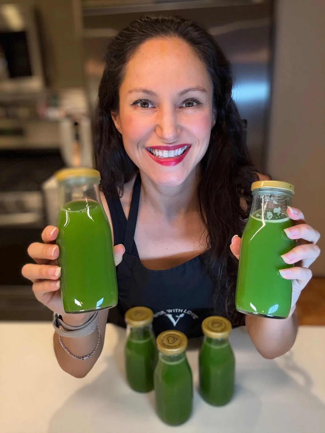 Cheryl holding fresh green juices